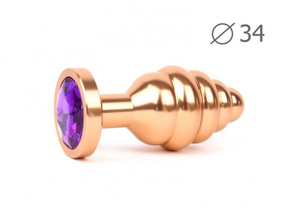 Коническая ребристая золотистая анальная втулка с кристаллом фиолетового цвета - 8 см. Коническая ребристая золотистая анальная втулка с кристаллом фиолетового цвета - 8 см.